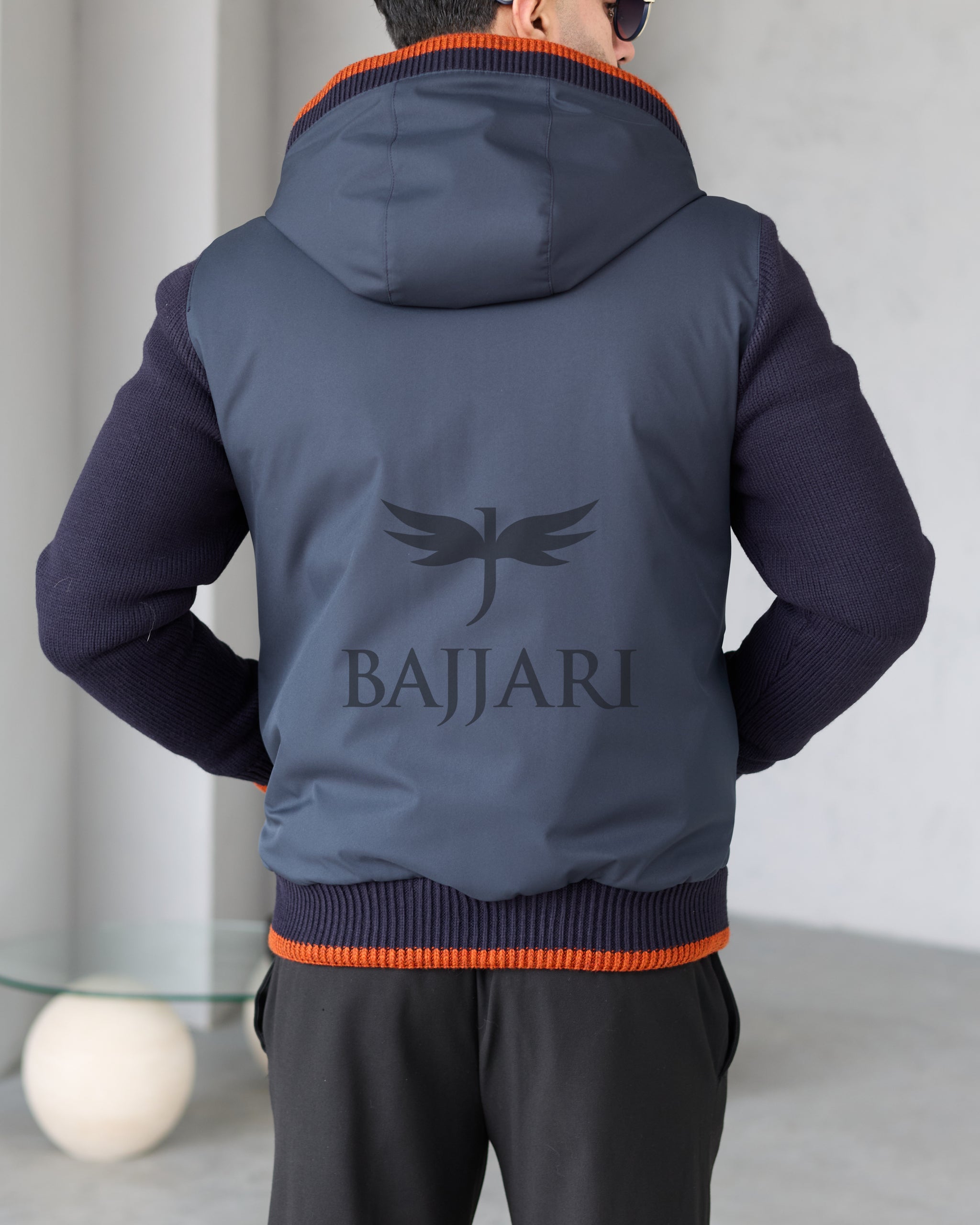 Men's hooded jacket with fur lining, knitted fabric sleeves, and waterproof fabric